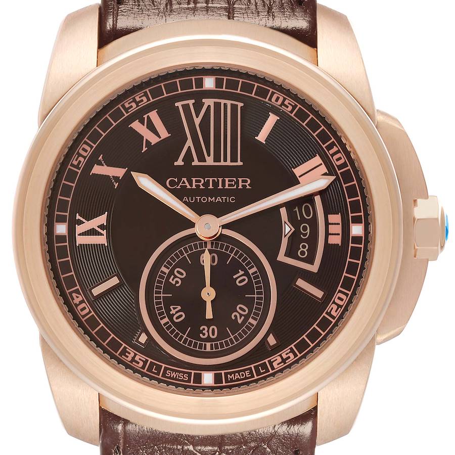 The Calibre de Cartier model W7100007 watch is shown from the front, highlighting its dial, numerals, hands, subdial, date window, crown, and leather strap.