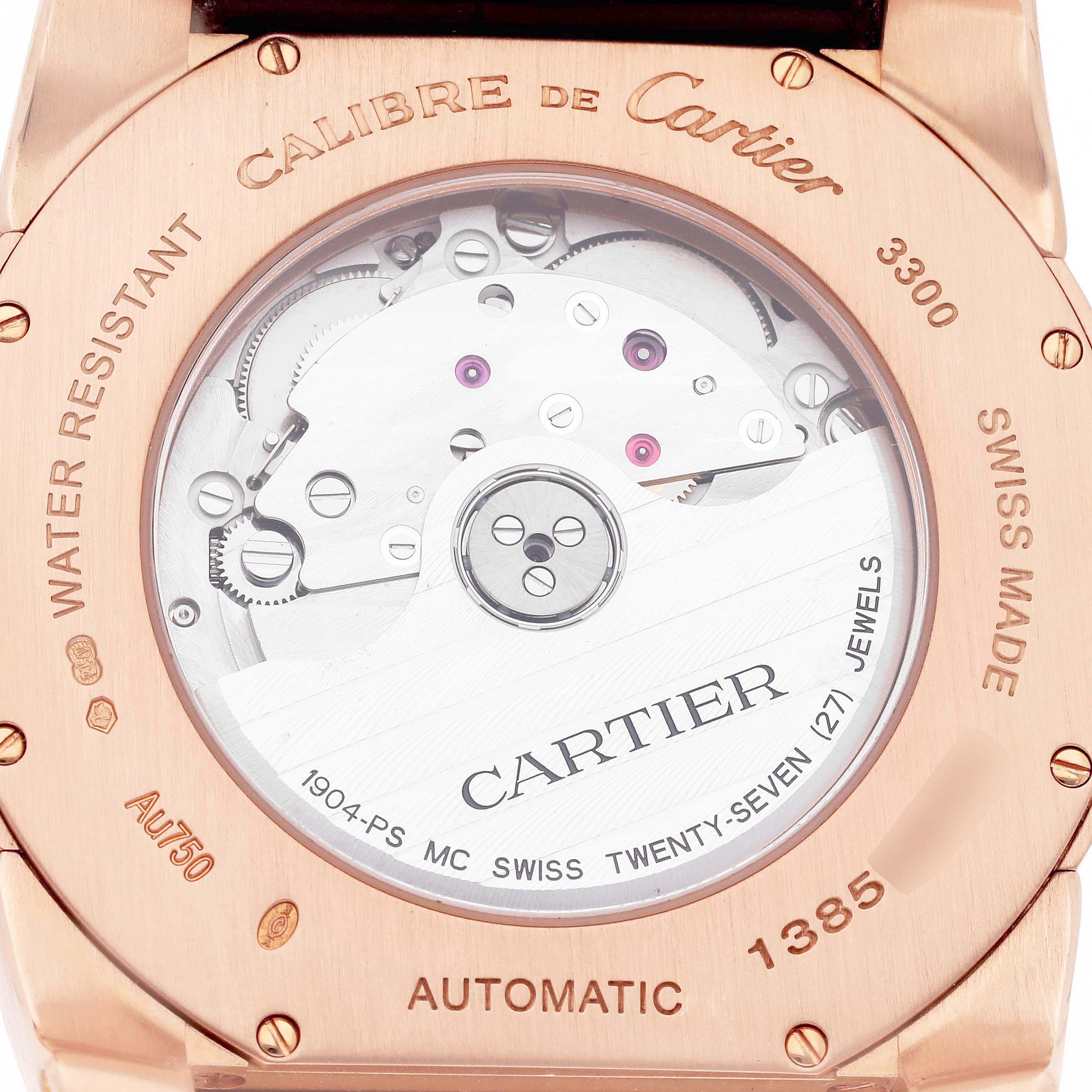 The image shows the case back of a Calibre de Cartier men's watch, model W7100007, with visible mechanical movement and branding engravings.
