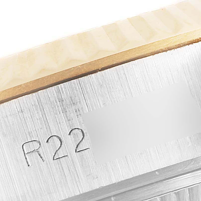 This image shows a close-up of the side of the bezel and case with engraving on a Rolex Datejust 69173 Women's Steel and Gold (two tone) Champagne Dial 69173 Women's Steel and Gold (two tone) Champagne Dial watch.