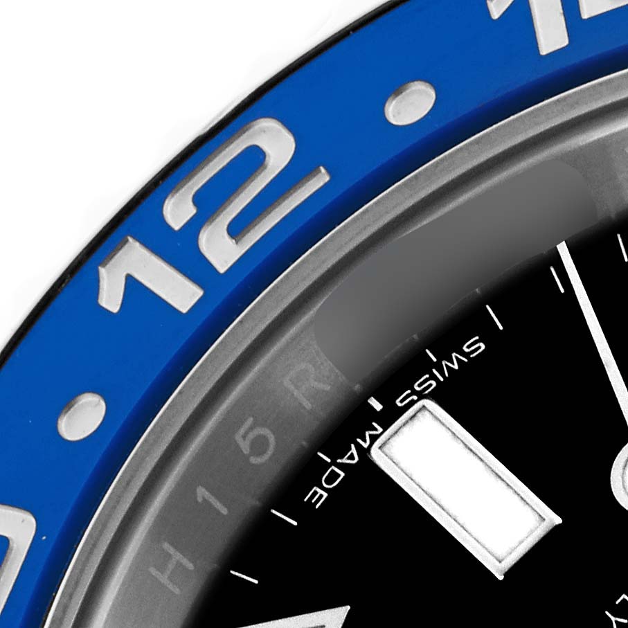The image shows a close-up of the Rolex GMT-Master 116710BLNR Men's Stainless Steel Black Dial 116710BLNR Men's Stainless Steel Black Dial's bezel and part of the dial, focusing on the "12" marker and "Swiss Made" text.