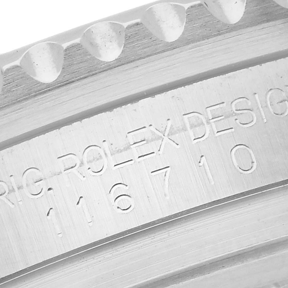 The image shows a close-up of the Rolex GMT-Master 116710BLNR Men's Stainless Steel Black Dial 116710BLNR Men's Stainless Steel Black Dial model’s engraved bezel and case details.