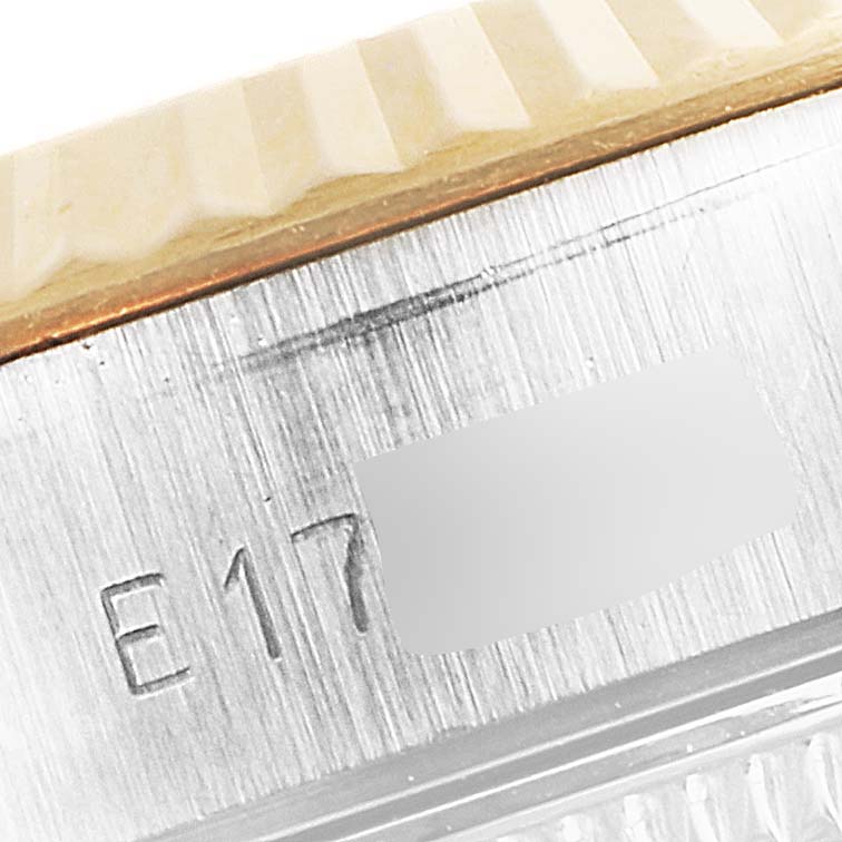This close-up image shows a portion of the case and bezel of a Rolex Datejust 69173 Women's Steel and Gold (two tone) Champagne Dial 69173 Women's Steel and Gold (two tone) Champagne Dial watch, highlighting the serial number engraving.