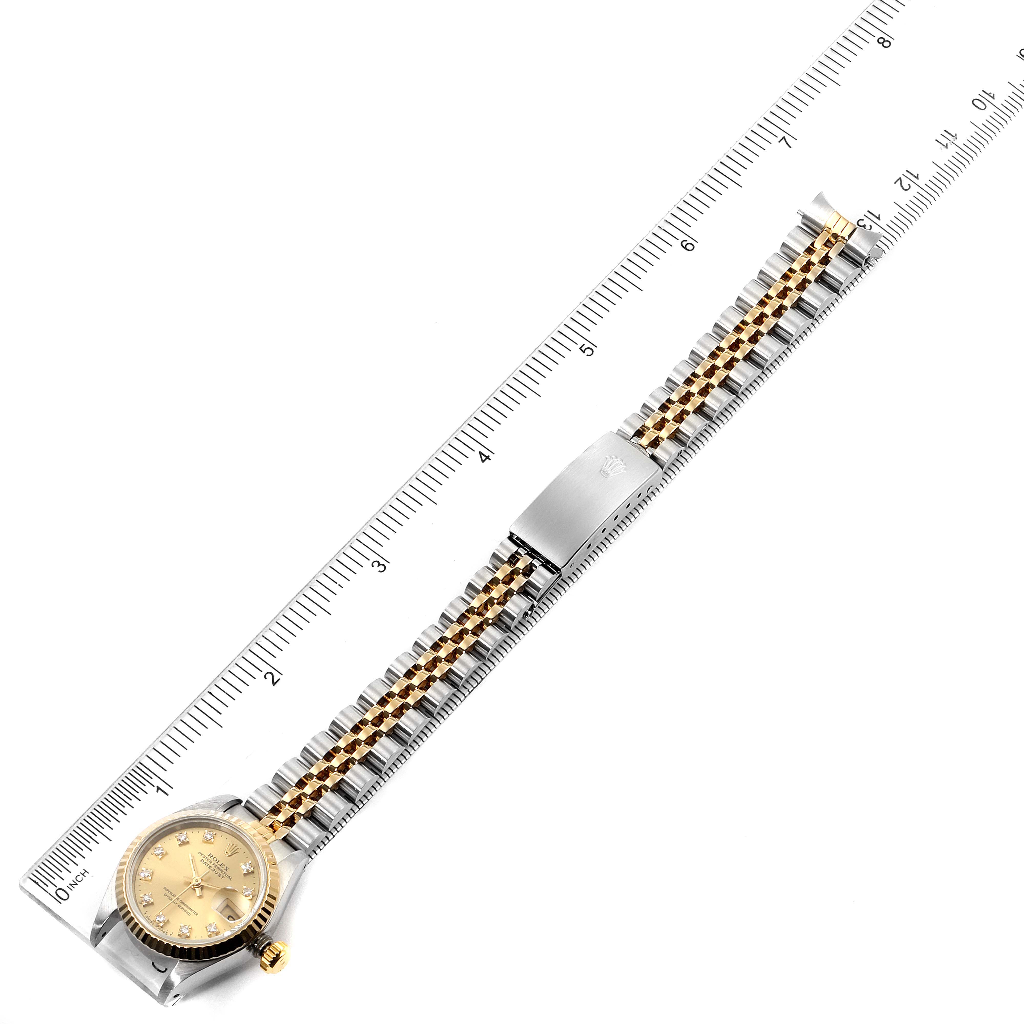 The image shows a top view of a Rolex Datejust 69173 Women's Steel and Gold (two tone) Champagne Dial 69173 Women's Steel and Gold (two tone) Champagne Dial watch with a ruler measuring the full length of the watch and band.