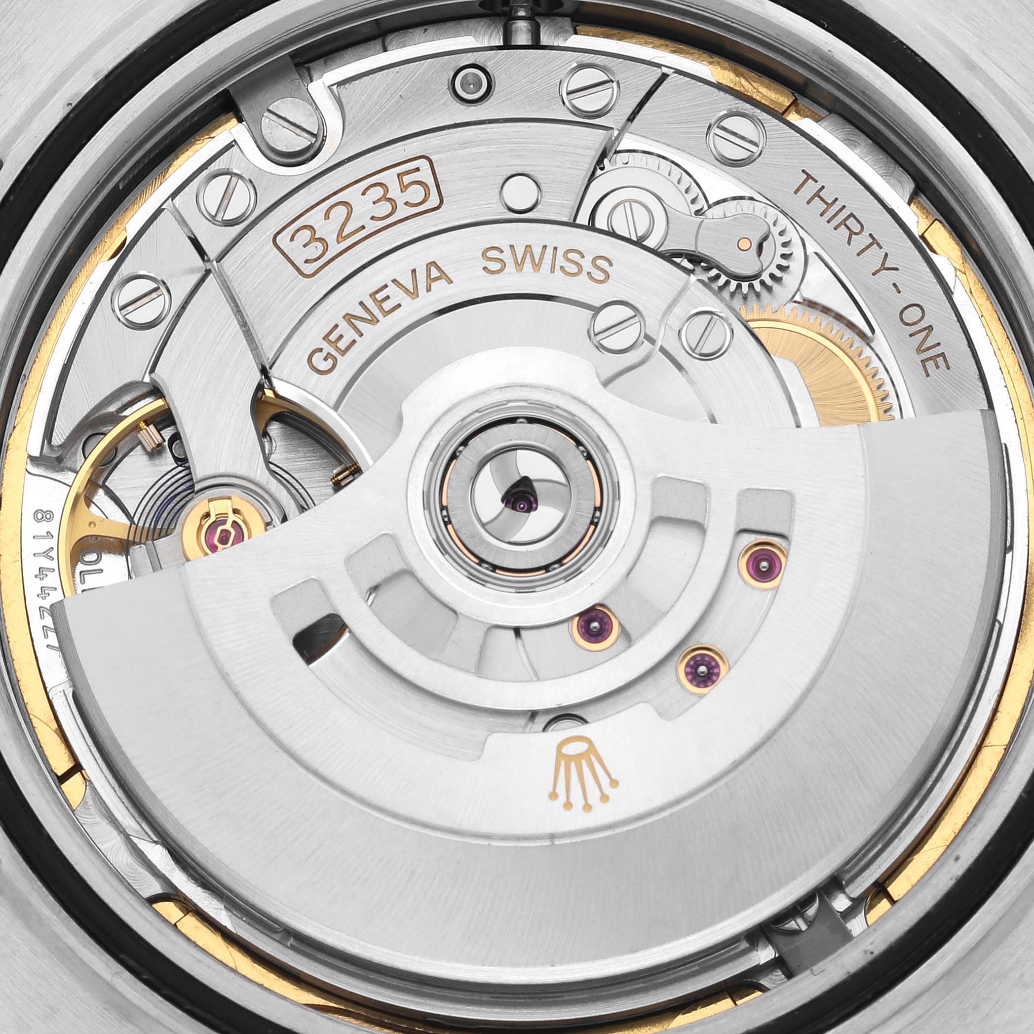 The image shows the movement mechanism of the Rolex Datejust 41 126331 Men's Steel and Gold (two tone) Brown Dial 126331 Men's Steel and Gold (two tone) Brown Dial from a rear angle, highlighting its intricate components.