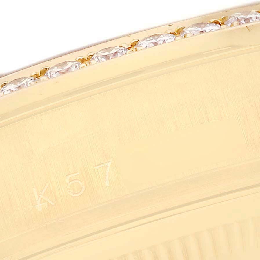The image shows a close-up of the bezel with diamonds and engraving on the Rolex President 118348 Men's Yellow Gold Champagne Dial 118348 Men's Yellow Gold Champagne Dial watch.