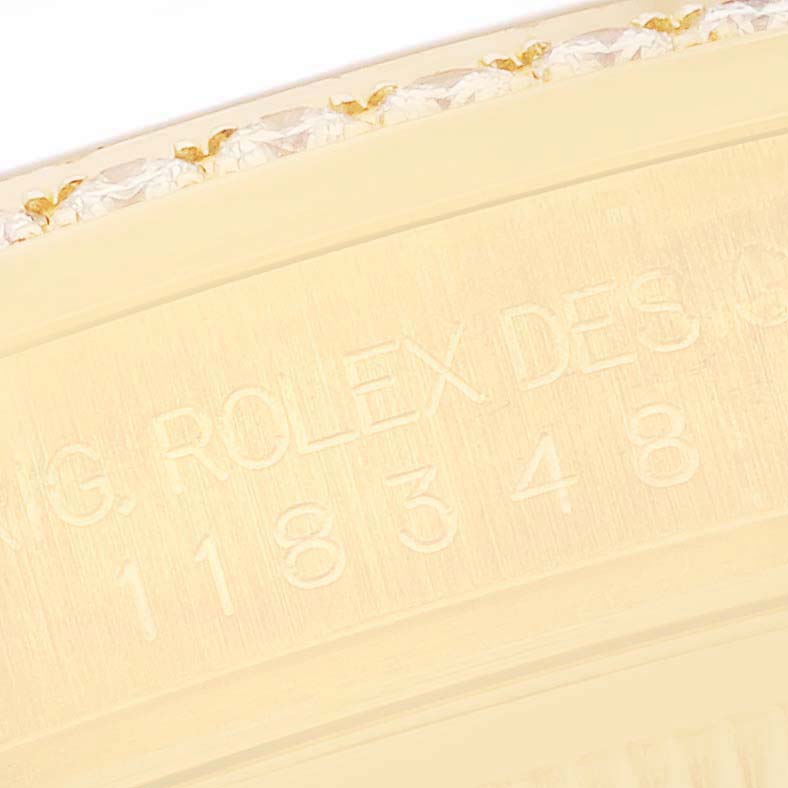 The image shows a close-up view of the Rolex President 118348 Men's Yellow Gold Champagne Dial 118348 Men's Yellow Gold Champagne Dial model bezel with engraved details.