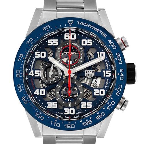 The image shows a Tag Heuer Carrera CAR2A1K.BA0703 Men's Stainless Steel Blue Dial CAR2A1K.BA0703 Men's Stainless Steel Blue Dial watch from a frontal angle, highlighting its detailed face, tachymeter bezel, and stainless-steel bracelet.