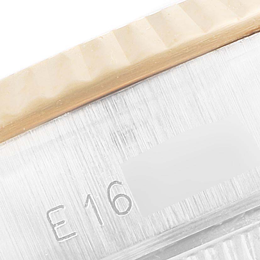 This image shows a close-up of the bezel and part of the case back with markings of the Rolex Datejust 69173 Women's Steel and Gold (two tone) Champagne Dial 69173 Women's Steel and Gold (two tone) Champagne Dial watch.