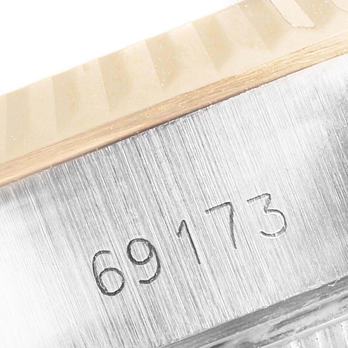 This image shows a close-up angle of the serial number "69173" engraved on the case of the Rolex Datejust 69173 Women's Steel and Gold (two tone) Champagne Dial 69173 Women's Steel and Gold (two tone) Champagne Dial watch.