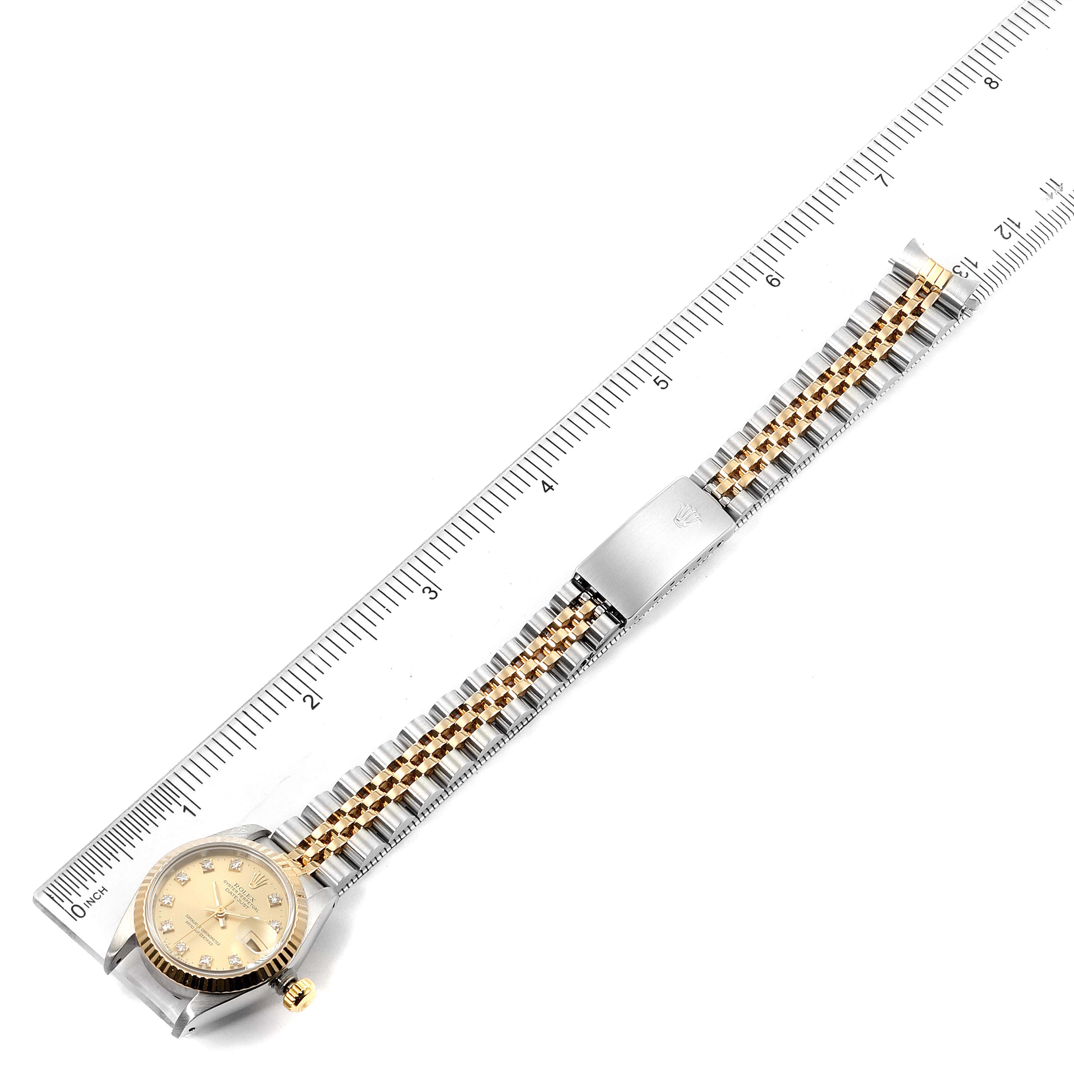 The image shows a top-down view of a Rolex Datejust 69173 Women's Steel and Gold (two tone) Champagne Dial 69173 Women's Steel and Gold (two tone) Champagne Dial watch alongside a ruler for size reference.