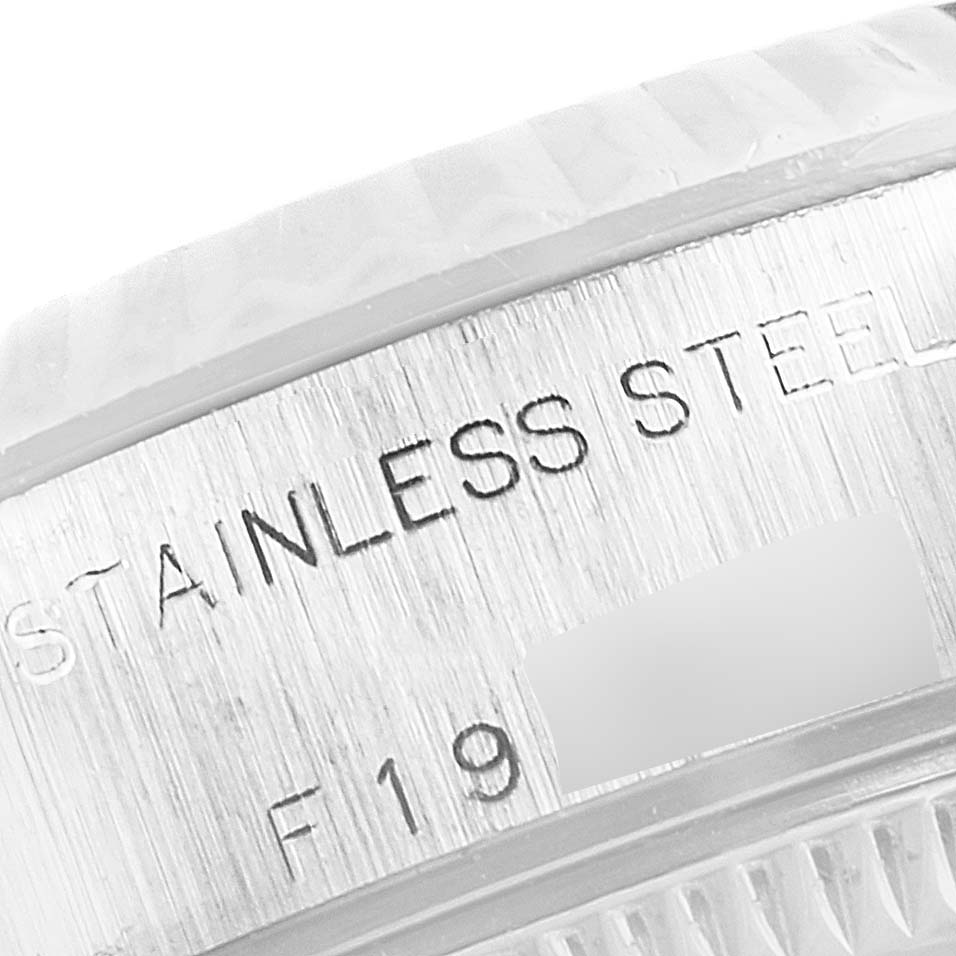 This close-up image shows the engraved stainless steel surface of the Rolex Datejust 79174 Women's Stainless Steel White Dial 79174 Women's Stainless Steel White Dial model.