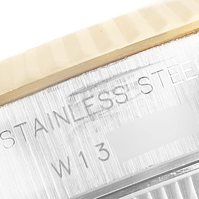 Close-up of the case side and bezel edge of a Rolex Datejust 69173 Women's Steel and Gold (two tone) Silver Dial 69173 Women's Steel and Gold (two tone) Silver Dial, showing "STAINLESS STEEL" engraving.