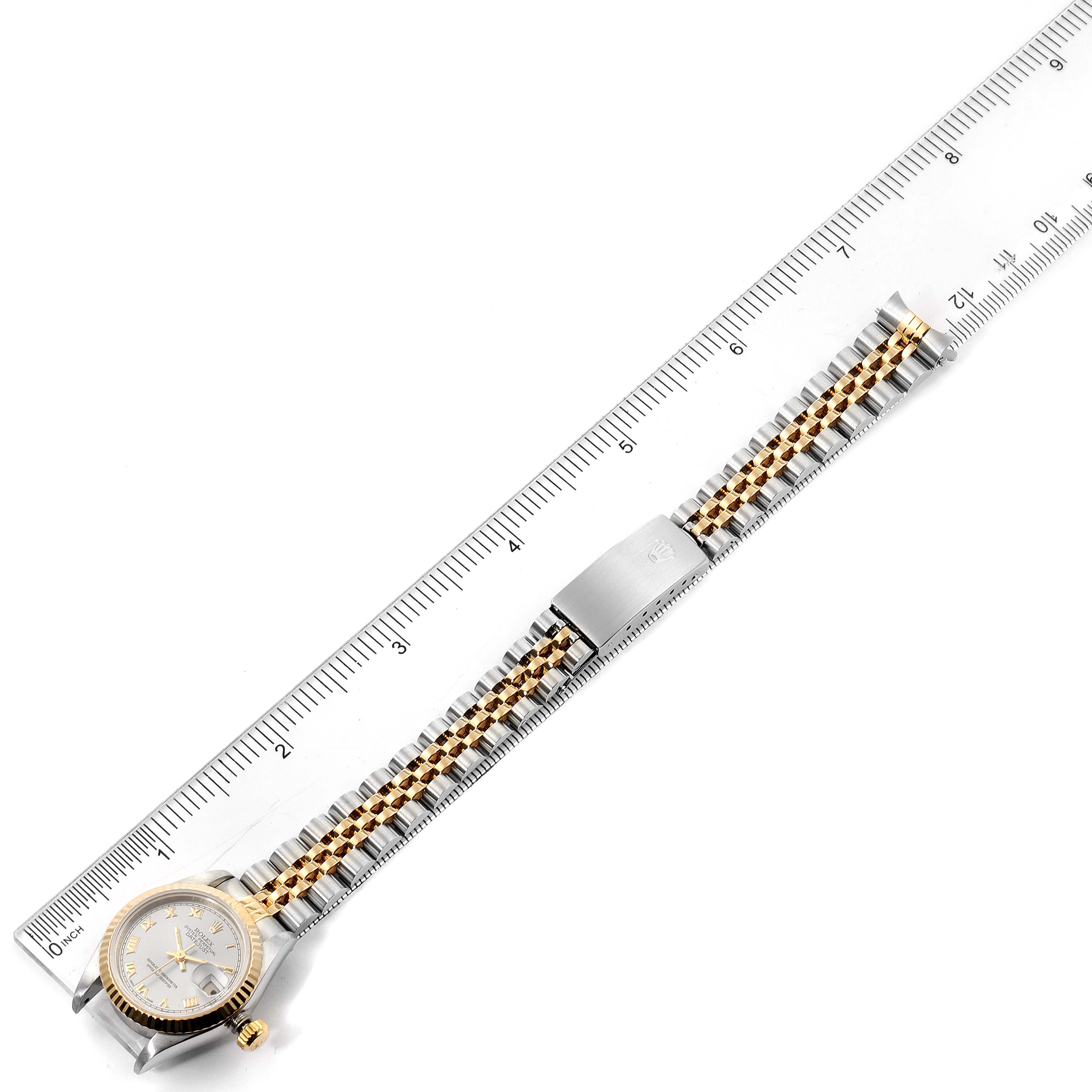 This image shows a Rolex Datejust 69173 Women's Steel and Gold (two tone) Silver Dial 69173 Women's Steel and Gold (two tone) Silver Dial watch laid flat next to a ruler, displaying the dial, case, and bracelet.