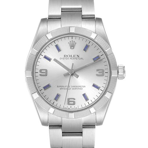 The Rolex Oyster Perpetual Mid-Size watch is shown from the front, highlighting the dial, bezel, and bracelet.