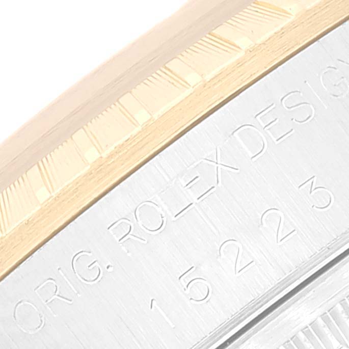 The image shows a close-up of the bezel and case side of a Rolex Date 15223 Men's Steel and Gold (two tone) Champagne Dial 15223 Men's Steel and Gold (two tone) Champagne Dial model watch, highlighting the engraved serial number and "Orig. Rolex Design" text.