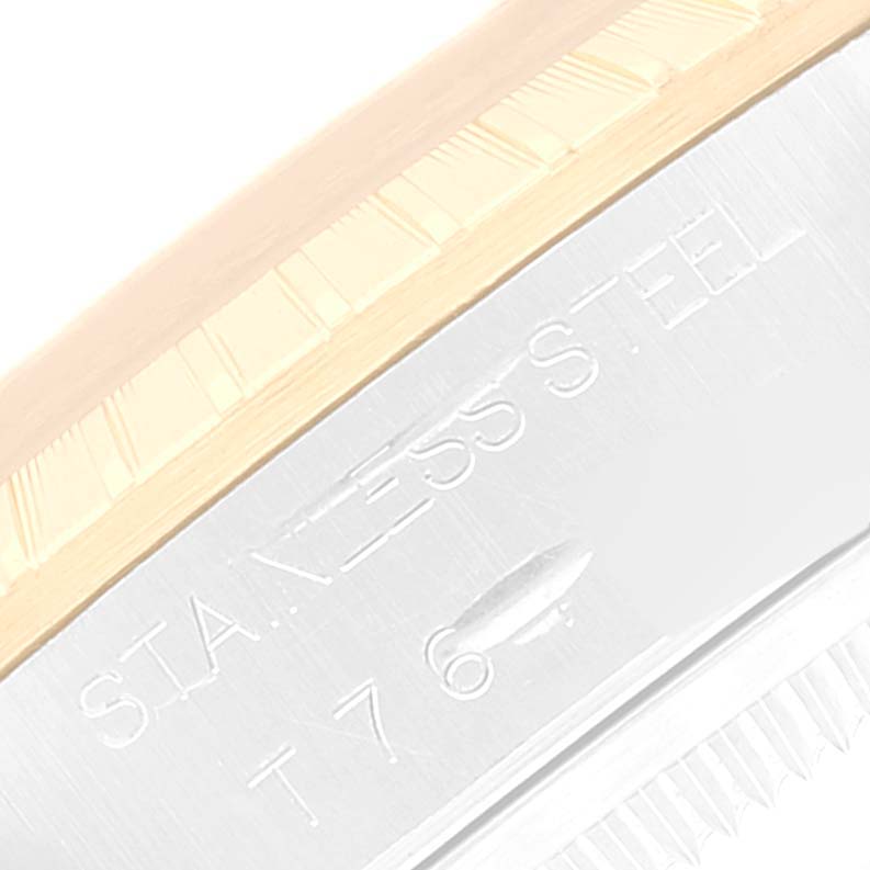 This close-up image shows the edge and engravings on the stainless steel part of a Rolex Date 15223 Men's Steel and Gold (two tone) Champagne Dial 15223 Men's Steel and Gold (two tone) Champagne Dial model.