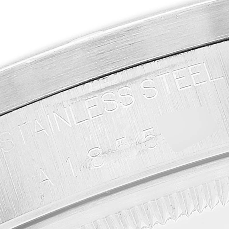 This image shows a close-up of the Date model by Rolex, focusing on the stainless steel caseback with engraved markings.
