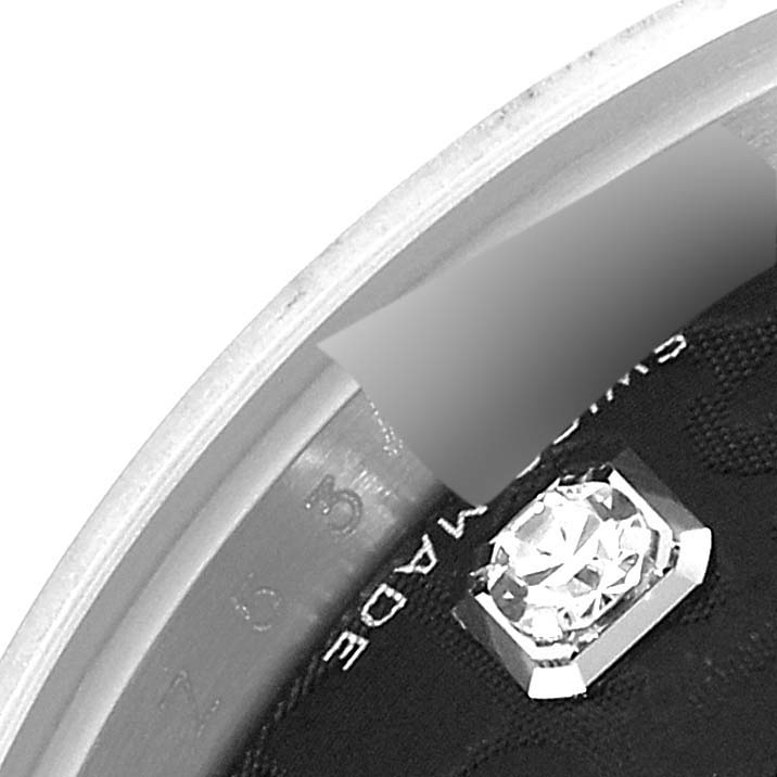 This image shows a close-up of the inner ring, inscription, and part of the dial of a Rolex Datejust 179174 Women's Stainless Steel Black Dial 179174 Women's Stainless Steel Black Dial watch.