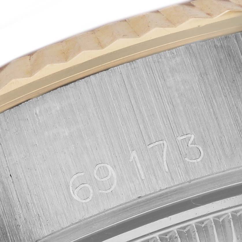 The image shows a close-up of the case side and bezel of a Rolex Date 69173 Women's Steel and Gold (two tone) White Dial 69173 Women's Steel and Gold (two tone) White Dial model, with engraved numbers visible.