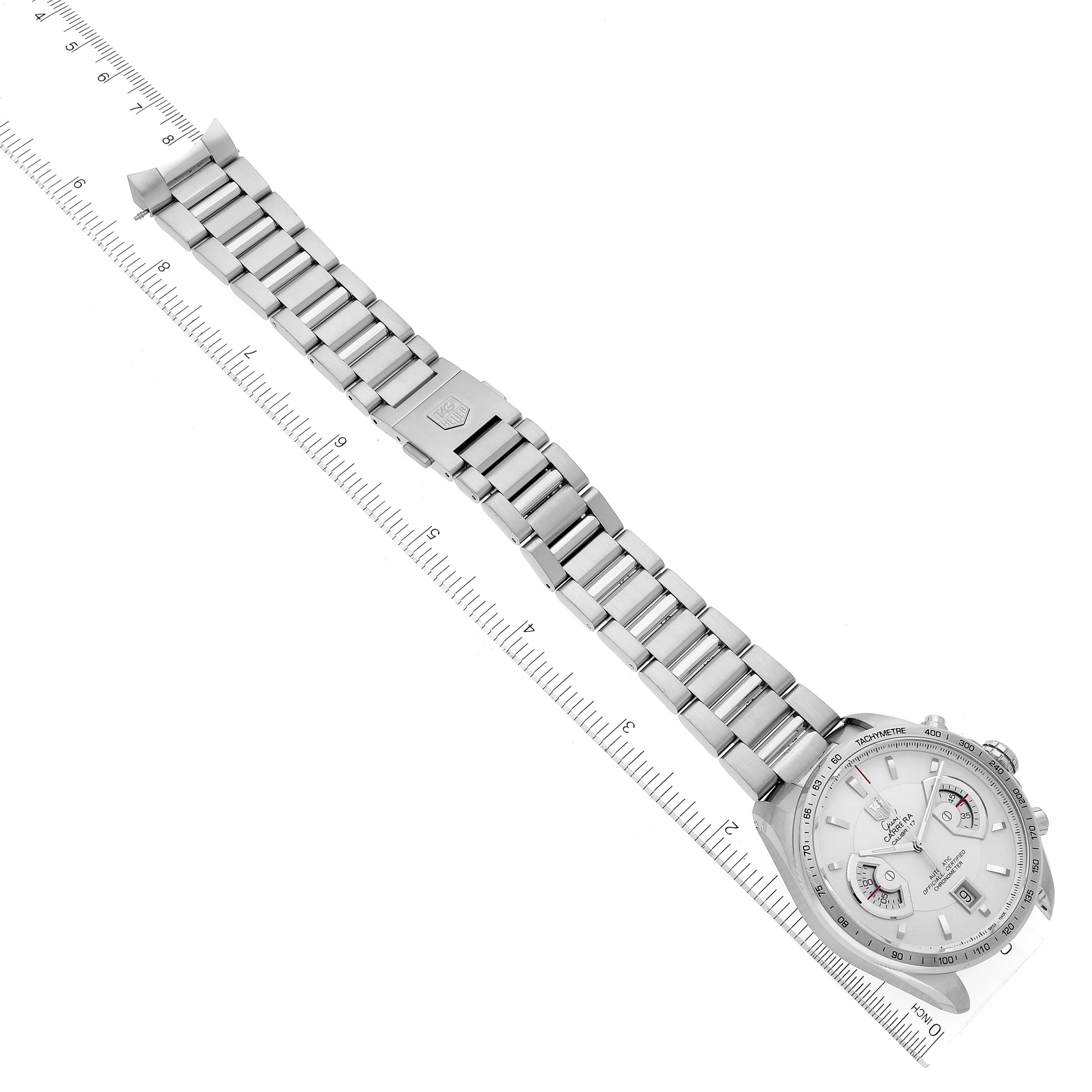The image shows a top-down view of a Tag Heuer Carrera CAV511B.BA0902 Men's Stainless Steel Silver Dial CAV511B.BA0902 Men's Stainless Steel Silver Dial watch, including the dial and full metal bracelet, placed on top of a ruler.