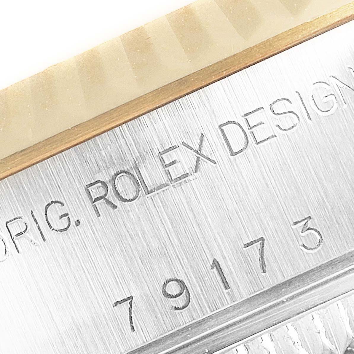 The image shows a close-up of the serial number and "Rolex Design" engraving on the case of a Rolex Datejust 79173 Women's Steel and Gold (two tone) Champagne Dial 79173 Women's Steel and Gold (two tone) Champagne Dial watch.