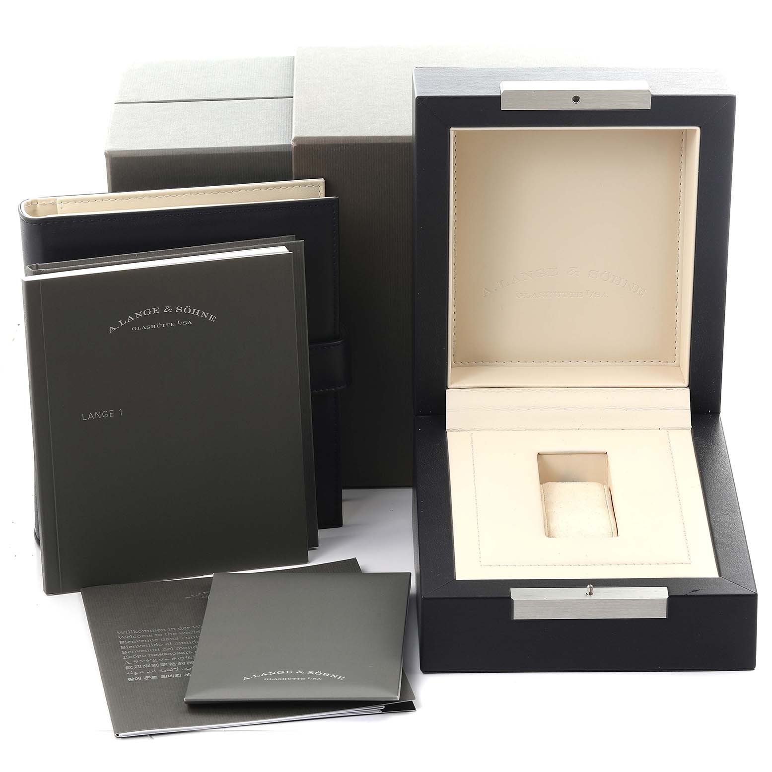 The image shows the empty box, manuals, and packaging for the Lange 1 watch by A. Lange & Söhne.