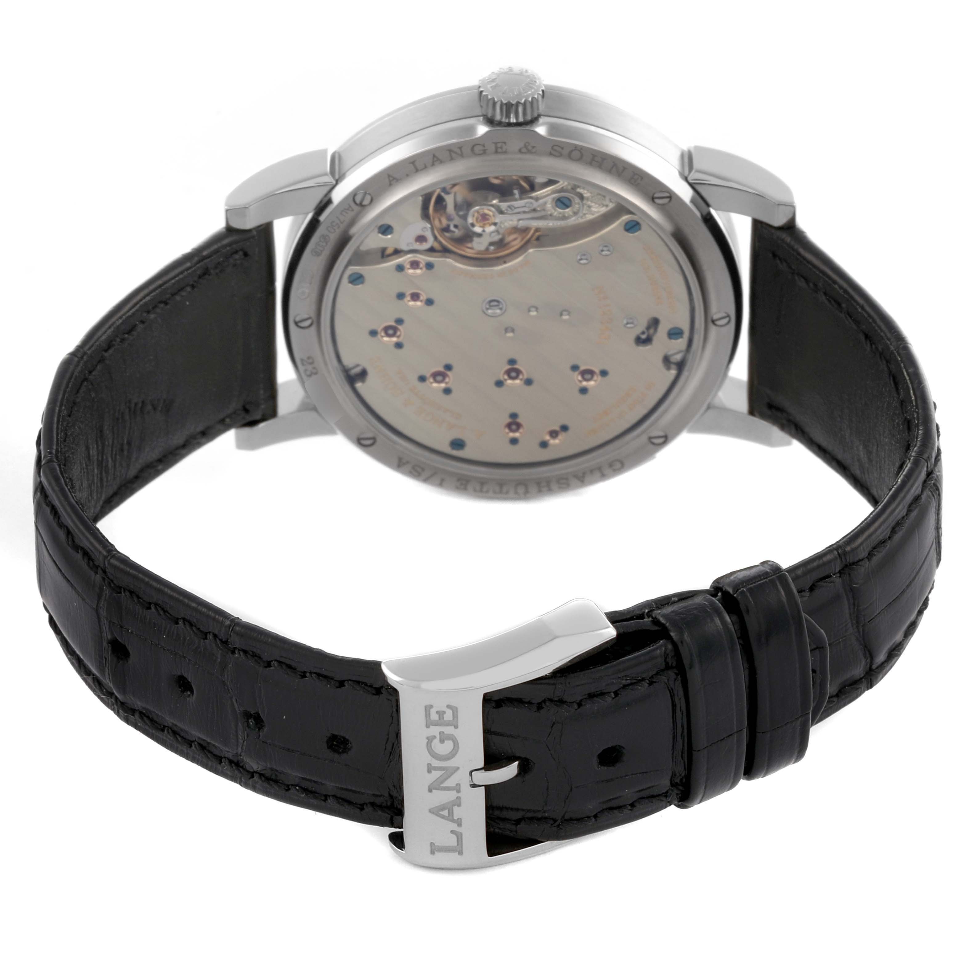 The image shows the back case and leather strap of the A. Lange & Sohne Lange 1 191.039 Men's White Gold Silver Dial watch at an angle displaying the movement.