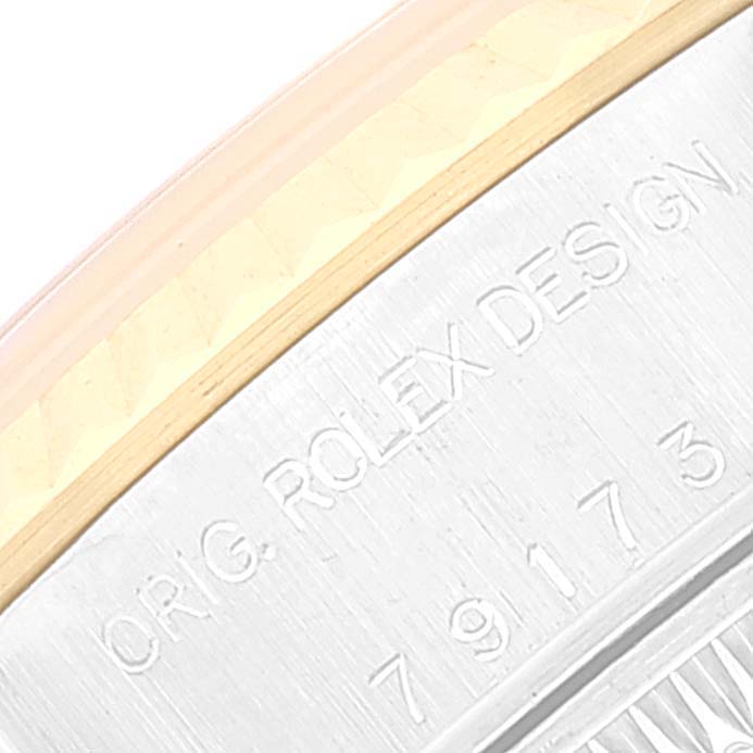 The image shows a close-up of the engraved numbers and "ORIG. ROLEX DESIGN" on the case of a Rolex Datejust 79173 Women's Steel and Gold (two tone) Champagne Dial 79173 Women's Steel and Gold (two tone) Champagne Dial watch.