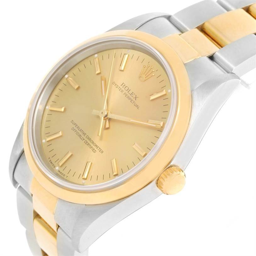 This image shows the Rolex Oyster Perpetual 14203 Men's Steel and Gold (two tone) Champagne Dial 14203 Men's Steel and Gold (two tone) Champagne Dial from an angled close-up, highlighting the dial, bezel, crown, and part of the bracelet.