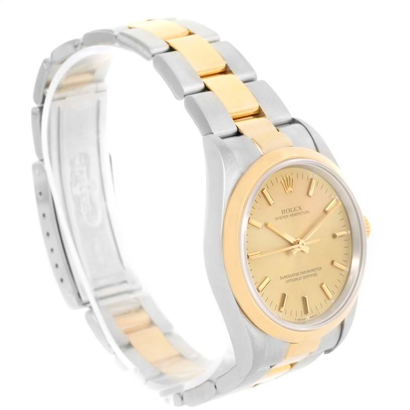 The Rolex Oyster Perpetual 14203 Men's Steel and Gold (two tone) Champagne Dial 14203 Men's Steel and Gold (two tone) Champagne Dial watch is shown at a front-side angle, highlighting its dial, case, and two-tone bracelet.