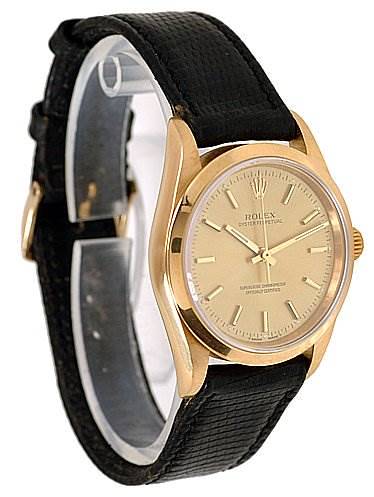 The image shows a side view of a Rolex Oyster Perpetual 14208 Men's Yellow Gold Champagne Dial 14208 Men's Yellow Gold Champagne Dial watch, displaying the face, bezel, and black leather strap.