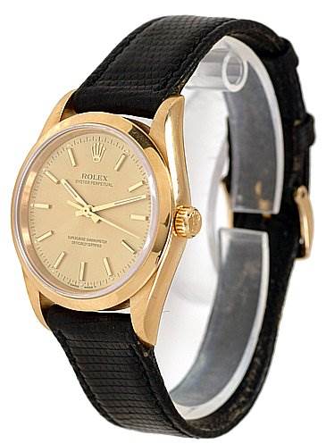 This is a frontal angle view of the Rolex Oyster Perpetual 14208 Men's Yellow Gold Champagne Dial 14208 Men's Yellow Gold Champagne Dial watch, showing the face, bezel, and strap.