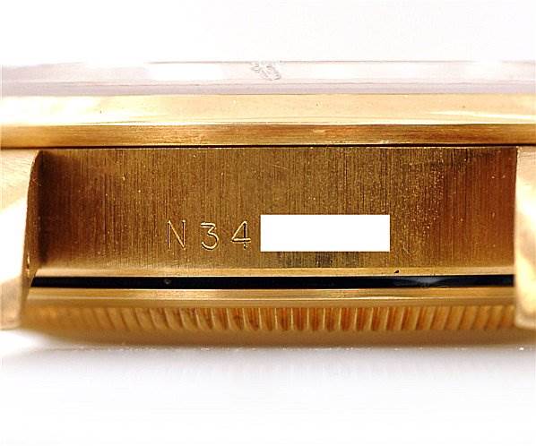 The image shows a close-up of the side case of a Rolex Oyster Perpetual 14208 Men's Yellow Gold Champagne Dial 14208 Men's Yellow Gold Champagne Dial watch, displaying the serial number.