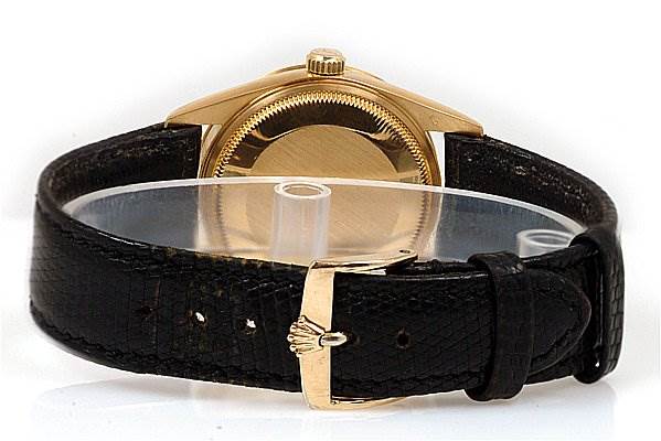 The image shows the back of a Rolex Oyster Perpetual 14208 Men's Yellow Gold Champagne Dial 14208 Men's Yellow Gold Champagne Dial watch, highlighting its case, crown, and black leather strap with a gold clasp.