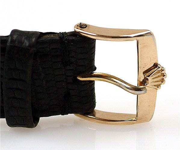 This image shows a close-up of the clasp and leather strap of a Rolex Oyster Perpetual 14208 Men's Yellow Gold Champagne Dial 14208 Men's Yellow Gold Champagne Dial watch.