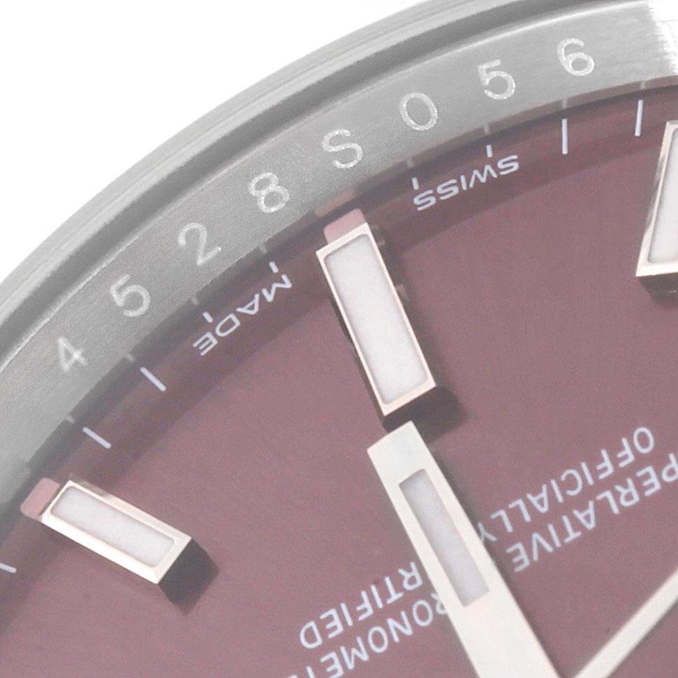 This is a close-up of the dial and hour markers of a Rolex Oyster Perpetual 114200 Men's Stainless Steel Burgundy Dial 114200 Men's Stainless Steel Burgundy Dial watch.