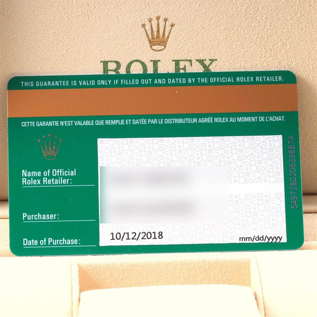 The image shows a guarantee card for a Rolex Oyster Perpetual 114200 Men's Stainless Steel Burgundy Dial 114200 Men's Stainless Steel Burgundy Dial watch, including the date of purchase and retailer information.