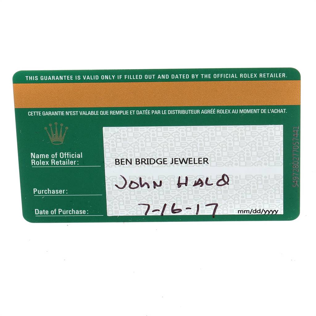 This image shows the warranty card for a Rolex Oyster Perpetual 114300 Men's Stainless Steel Burgundy Dial 114300 Men's Stainless Steel Burgundy Dial watch from a flat angle.