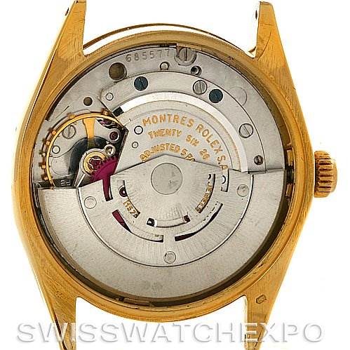 This image shows the back view of a Rolex Oyster Perpetual Men's Yellow Gold White Dial Men's Yellow Gold White Dial watch, highlighting its movement and inner workings.