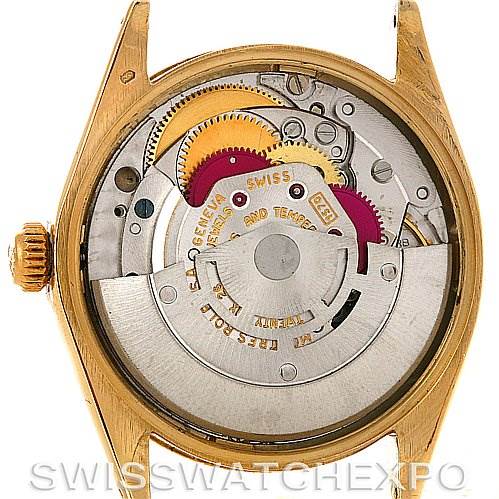 The image shows the back view of a Rolex Oyster Perpetual Men's Yellow Gold White Dial Men's Yellow Gold White Dial watch, revealing its internal mechanical movement components.