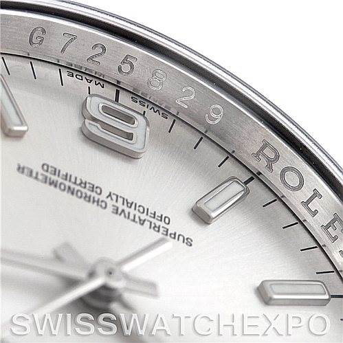 This image shows a close-up angle of the dial and bezel of a Rolex Oyster Perpetual 116000 Men's Stainless Steel Silver Dial 116000 Men's Stainless Steel Silver Dial watch, highlighting numerals and text.