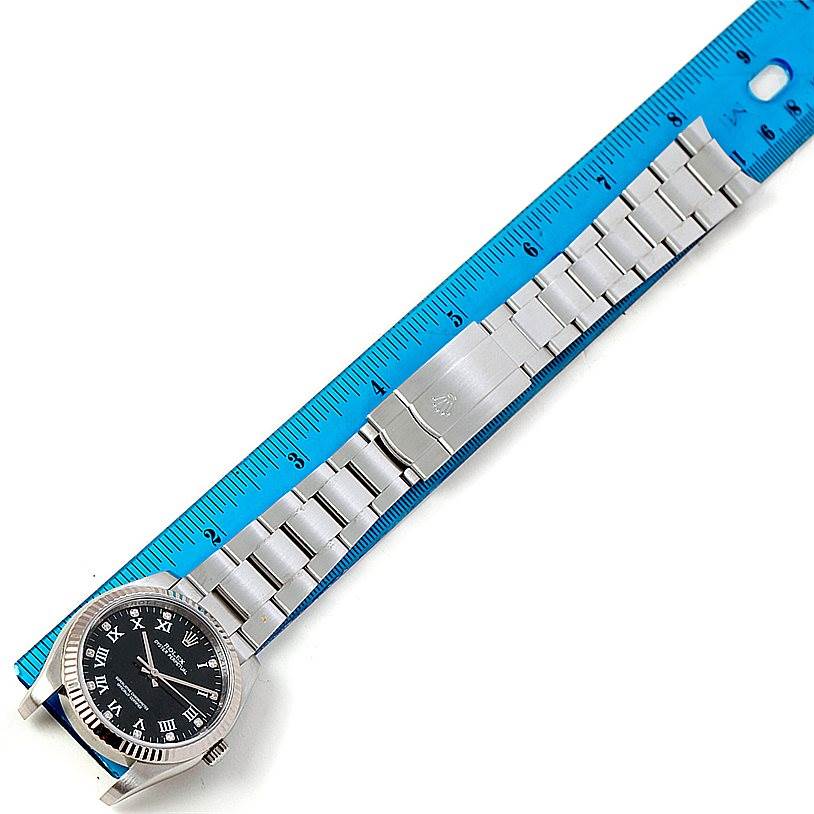 The image shows a Rolex Oyster Perpetual 116034 Men's Stainless Steel Black Dial 116034 Men's Stainless Steel Black Dial watch laid alongside a ruler, highlighting the face and full bracelet.