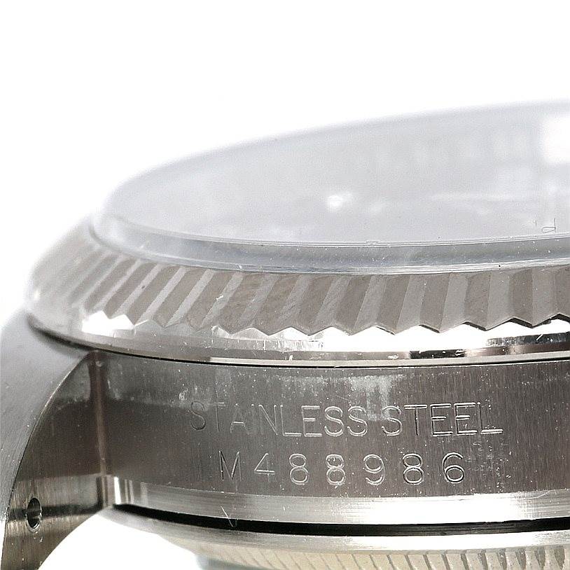 The image shows the side view of a Rolex Oyster Perpetual 116034 Men's Stainless Steel Black Dial 116034 Men's Stainless Steel Black Dial watch, highlighting the stainless steel case and part of the bezel.