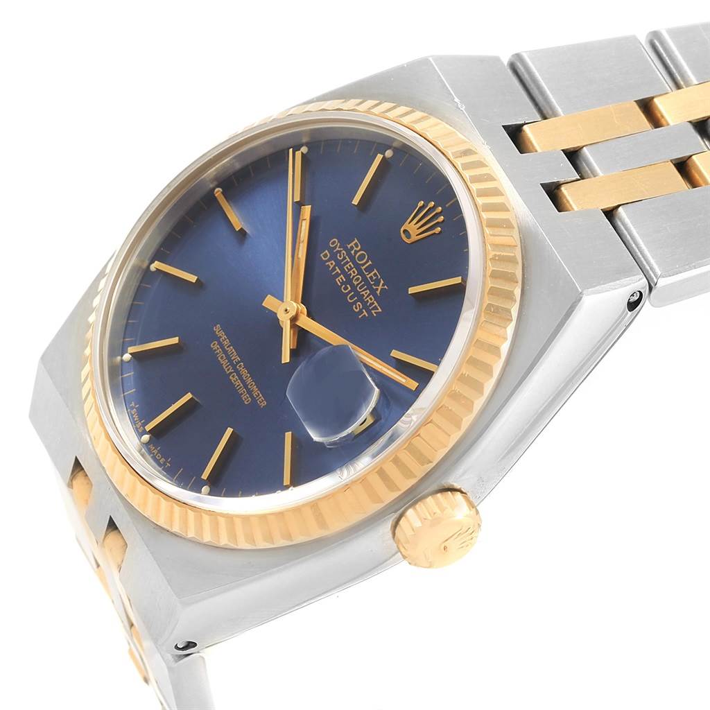 The image shows a close-up angled view of a Rolex Oysterquartz 17013 Men's Stainless Steel Blue Dial 17013 Men's Stainless Steel Blue Dial watch, revealing the blue dial, gold fluted bezel, and part of the bracelet.