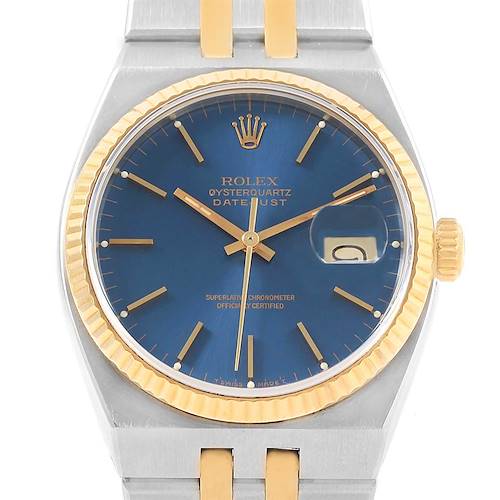 This image shows a Rolex Oysterquartz 17013 Men's Stainless Steel Blue Dial 17013 Men's Stainless Steel Blue Dial Datejust watch at a front angle, highlighting its blue dial, gold bezel, and part of the bracelet.