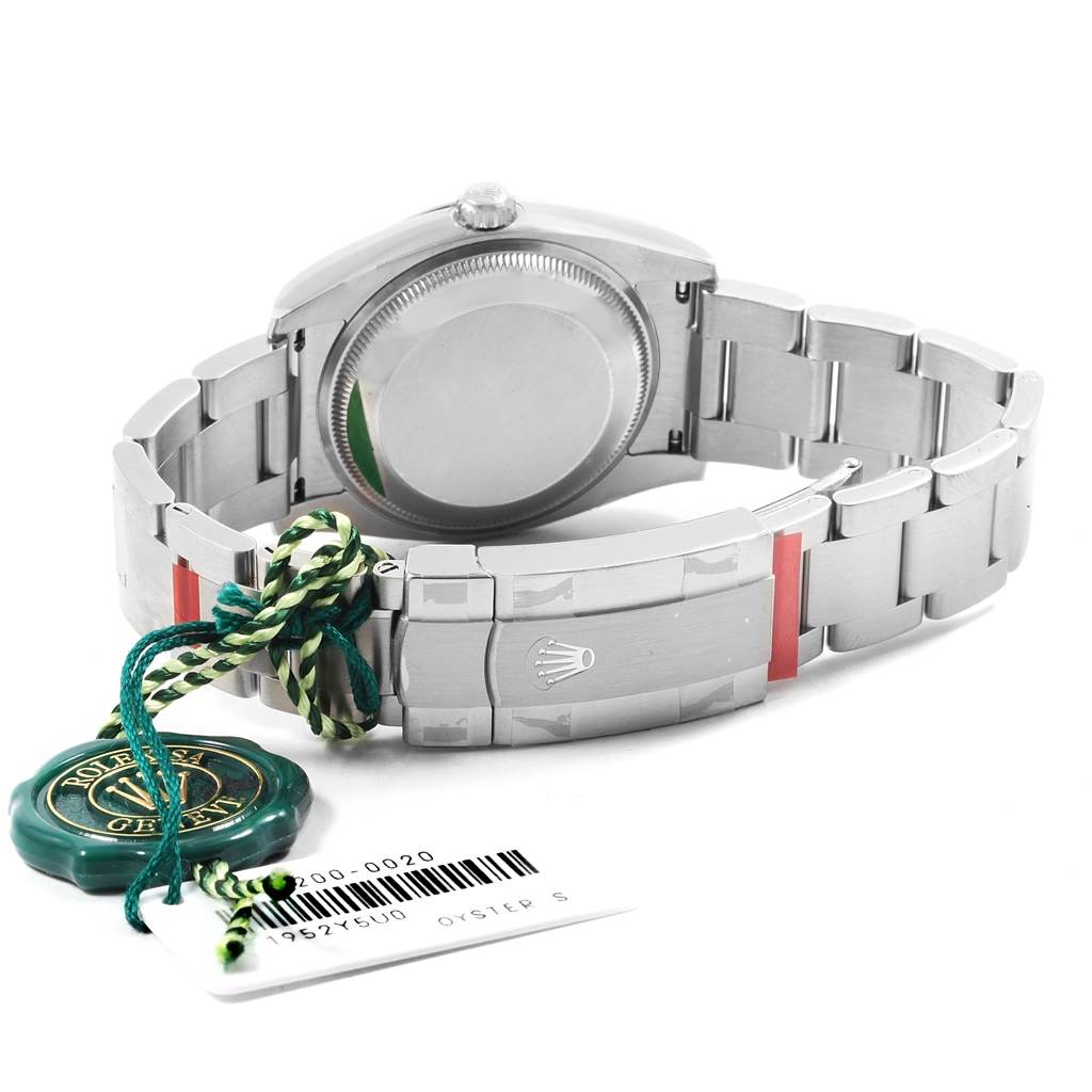 The image shows the back and the clasp of the Rolex Oysterquartz 114200 Men's Stainless Steel Burgundy Dial 114200 Men's Stainless Steel Burgundy Dial watch, along with attached tags.