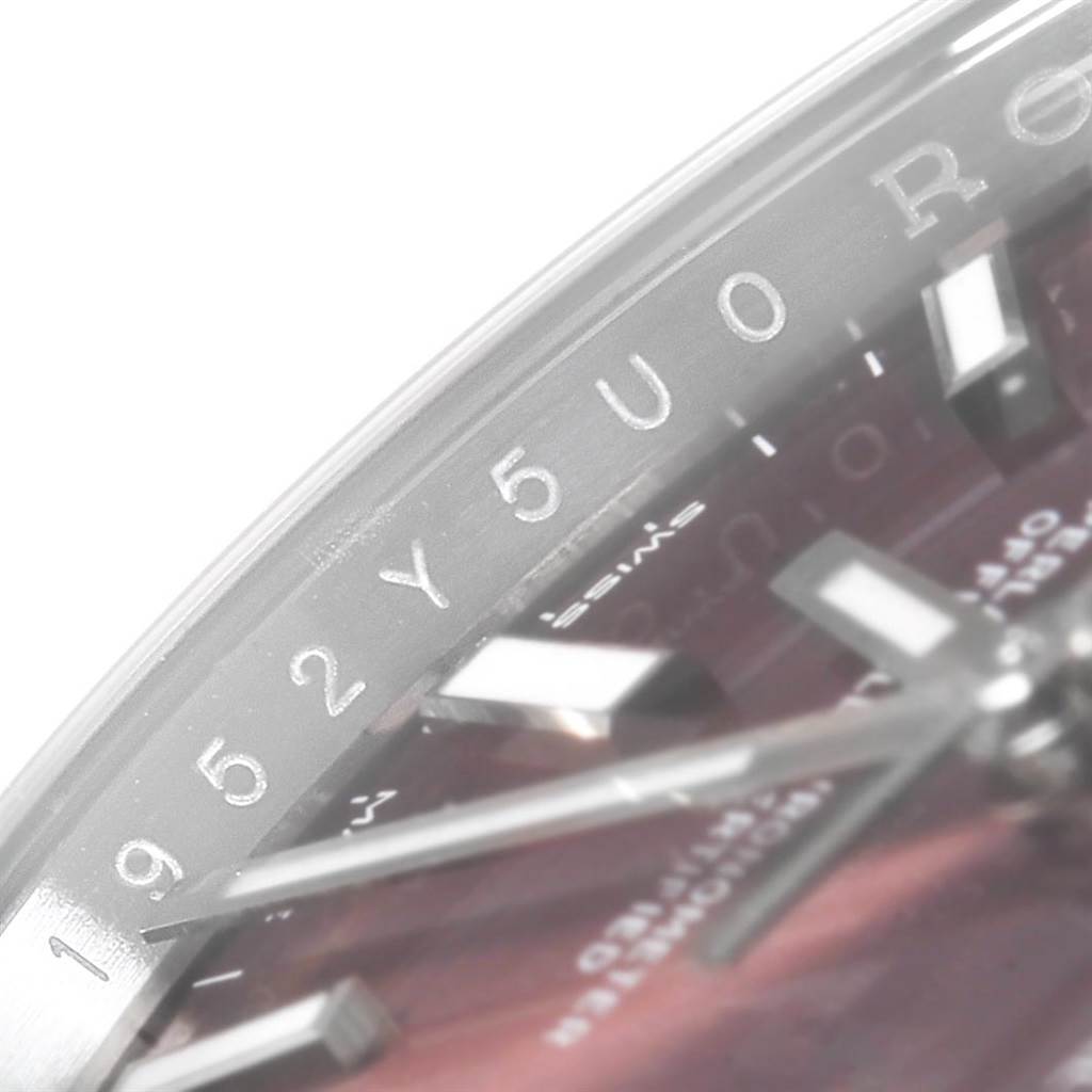 The image shows a close-up of the dial, hands, and inner bezel of a Rolex Oysterquartz 114200 Men's Stainless Steel Burgundy Dial 114200 Men's Stainless Steel Burgundy Dial watch.