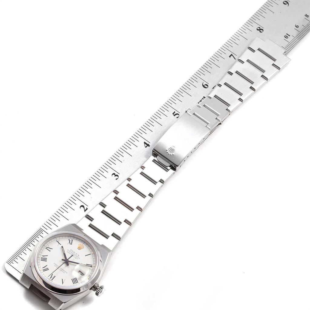 The image displays the Rolex Oysterquartz 17000 Men's Stainless Steel White Dial 17000 Men's Stainless Steel White Dial watch laid alongside a ruler, showing the watch face, bracelet, and clasp from a top-down angle.