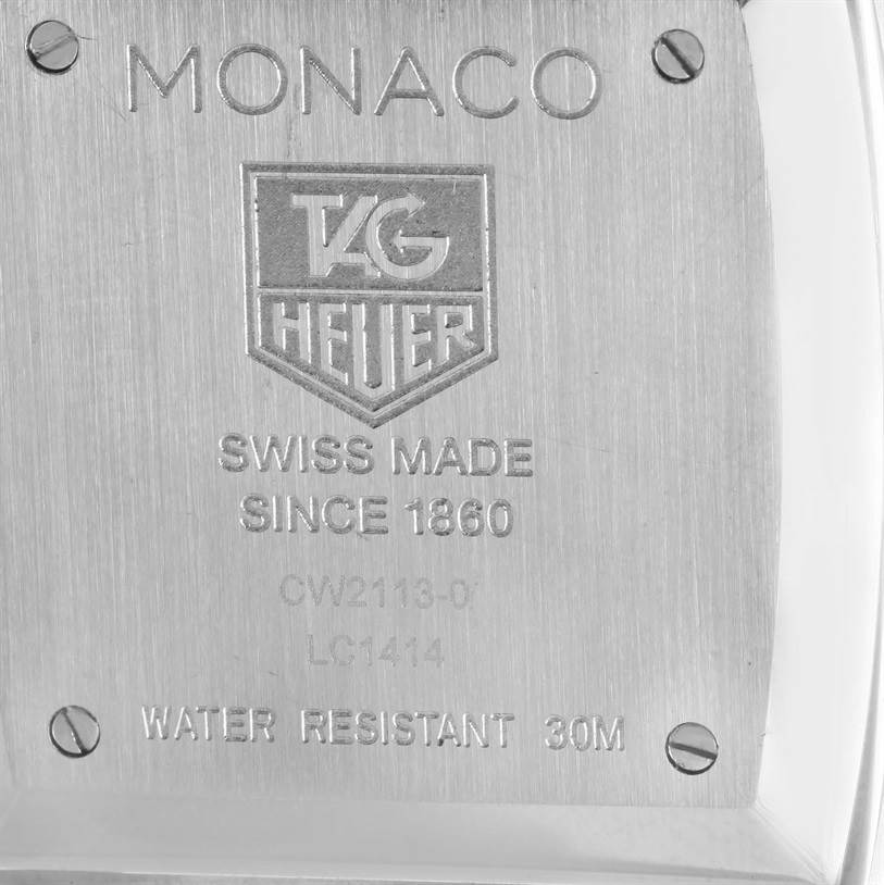The image shows the back side of a Tag Heuer Monaco CW2113 Men's Stainless Steel Blue Dial CW2113 Men's Stainless Steel Blue Dial watch, highlighting its engravings and screw details.