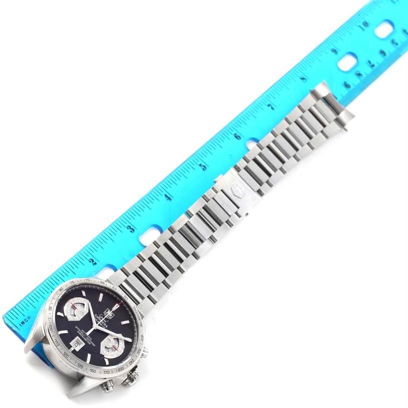 The image shows a Tag Heuer Carrera CAV511A Men's Stainless Steel Black Dial CAV511A Men's Stainless Steel Black Dial watch with a metal bracelet aligned next to a blue ruler for scale.